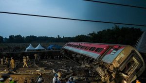 Iniinspeksyon ng mga pulis ang lugar ng aksidente ng mga bangkay ng karwahe ng isang banggaan ng tatlong tren malapit sa Balasore, sa silangang estado ng Odisha ng India, noong Hunyo 3, 2023. — AFP